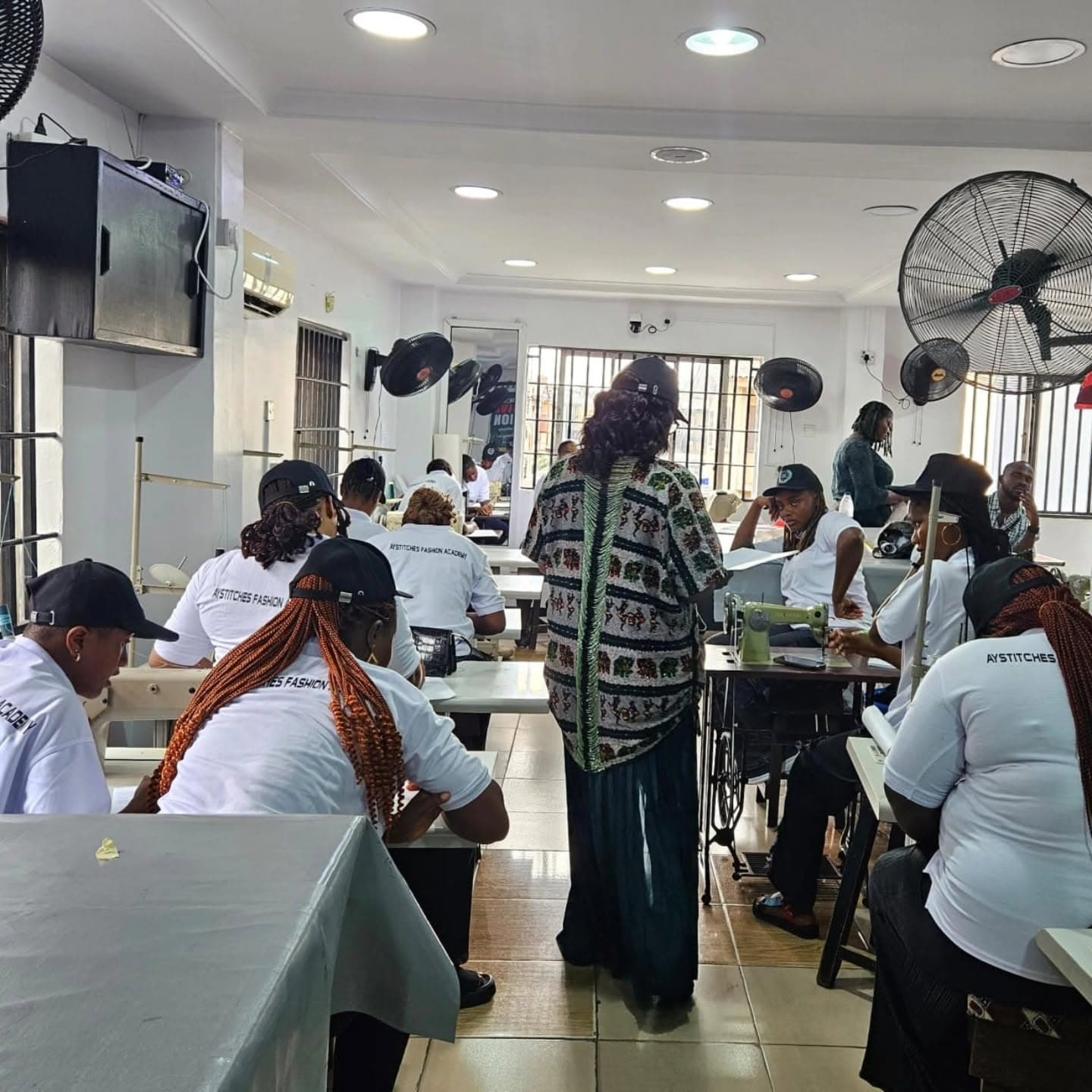 Students learning at Ay Stitches Fashion Academy