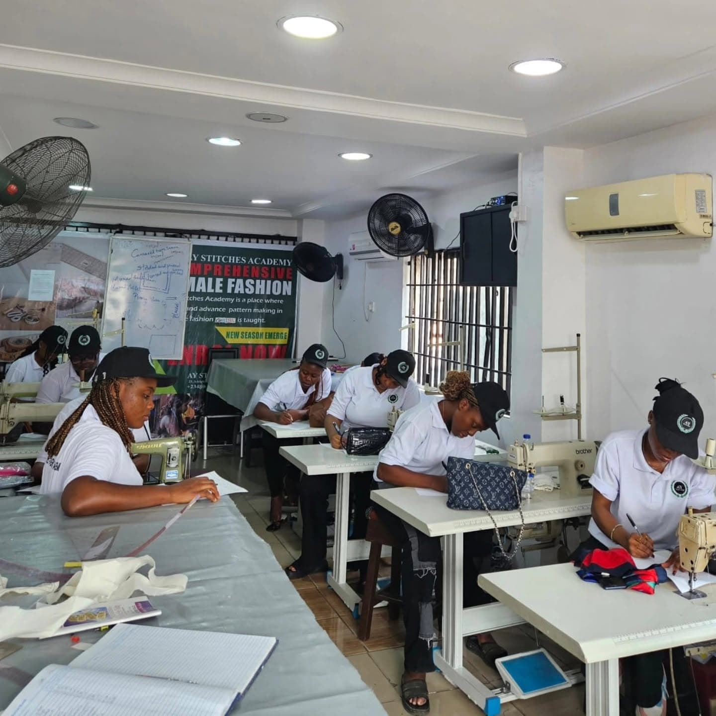 Students at Ay Stitches Fashion Academy working at sewing machines